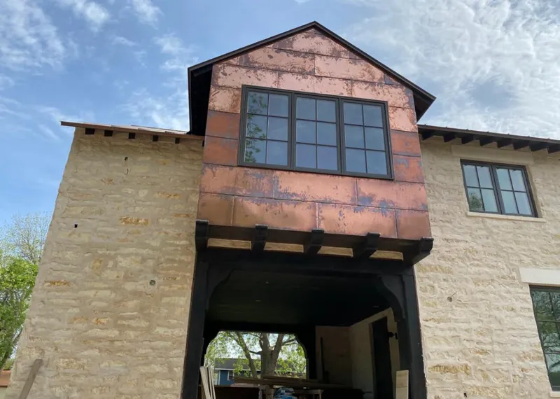 Copper metal panel facade on a stone building for Skylight Installation in Desert Palms